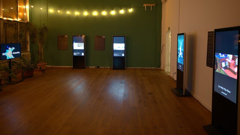 An open gallery floor, warmly lit, with digital frames dotted around.